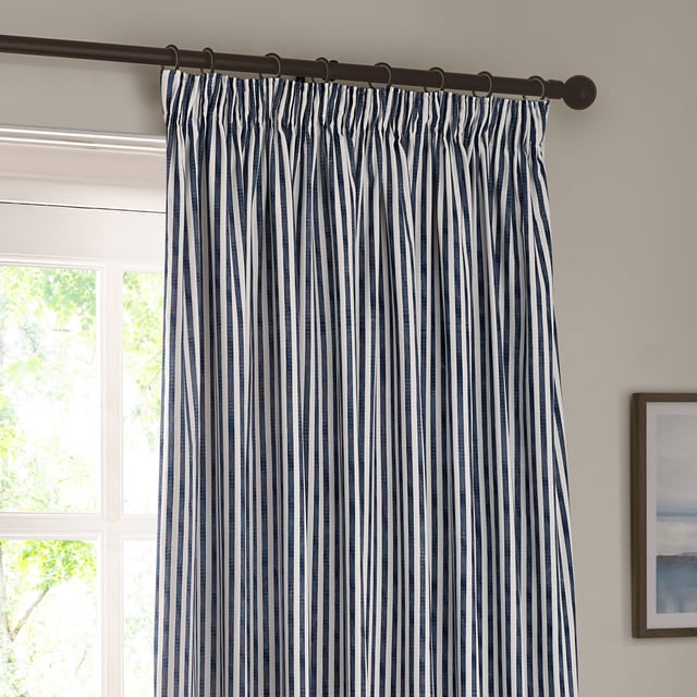 Transform your living space into a sanctuary with Hebden Striped Pencil Pleat Curtains. Crafted from 100% cotton, these curtains offer a soft, yet durable touch. The timeless, textured stripe design complements any minimalist or classic décor, while the room-darkening lining provides the perfect retreat from the outside world. Perfect for those who value natural materials, Hebden curtains are an investment in comfort and style, enriching your home environment without compromise.