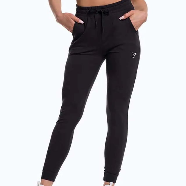 Gymshark Pippa Womenâ€™s Black Track Pants, designed for both style and performance. These track pants seamlessly blend comfort and functionality, making them the perfect choice for workouts, casual outings, or lounging at home. With a sleek design and practical features, the Pippa track pants are a versatile addition to your activewear collection.
Â 
Key Features:
Premium Fabric: 

Made from a high-quality blend of soft and stretchy materials, these track pants provide a comfortable fit that moves with you. The breathable fabric ensures optimal ventilation, keeping you cool and dry during workouts or everyday activities.

Slim Fit Design: 

The Pippa track pants feature a flattering slim fit that contours to your body without being restrictive. This stylish silhouette enhances your shape while allowing for freedom of movement, making them ideal for both active and casual wear.

Elasticated Waistband: 

Designed with an elasticated waistband and adjustable drawstring, these pants offer a customizable fit for maximum comfort. The waistband provides added support and helps keep the pants securely in place during physical activity.

Side Pockets: 

Equipped with practical side pockets, these track pants provide convenient storage for essentials like your phone, keys, or small gym accessories. The pockets are designed to be sleek and unobtrusive, maintaining the overall streamlined look of the pants.

Versatile Styling: 

The all-black design makes these track pants incredibly versatile, allowing you to easily pair them with a variety of tops and footwear. Dress them up with a stylish crop top and sneakers for a chic athleisure look, or keep it casual with a loose-fitting tee.

Gymshark Branding: 

Featuring the iconic Gymshark logo, the Pippa track pants reflect a commitment to quality and style. The subtle branding adds a touch of sophistication to the overall design.

Perfect for Any Activity: 

Whether youâ€™re hitting the gym, going for a jog, or simply relaxing at home, these track pants are suitable for a range of activities. Their stylish yet functional design makes them a go-to choice for any occasion.

Â 
In summary, the Gymshark Pippa Womenâ€™s Black Track Pants are a must-have for any active woman seeking comfort, style, and versatility. With their premium fabric, flattering fit, and practical features, these pants are perfect for workouts and everyday wear alike. Embrace your active lifestyle in style with Gymshark.