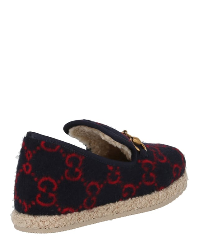 Heel measures at approximately: 0.4"; Slips on; 100% wool; Closed round toe,fur lining; Embellished with signature horsebit and knitted GG pattern;
