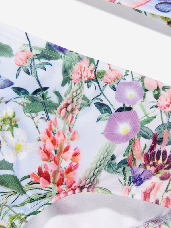 Introducing the Girls Floral Print Bikini In Multicolour, a statement piece for your Girl's summer wardrobe by Molo. Key features include: Chic Design: A vibrant floral print makes this bikini set a real eye-catcher, perfect for summertime swims and beach picnics. Premium Quality: Crafted from soft and durable materials, providing optimum comfort for your little one's aquatic adventures. Aesthetic Appeal: A Stylishly designed multicoloured bikini set that significantly elevates your girl's summer look!Add a pop of colour to your Girl's collection with the Floral Print Bikini by Molo in Multicolour. Don't miss out, order now!