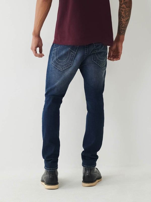Meet our ultra-slim Jack Jean. This distressed men's super skinny jean features fading, 3D whiskering, and ripped destruction. Finished with two tone stitching, 1/2" horseshoe detailing along the back pockets, and a shorter 30" inseam.