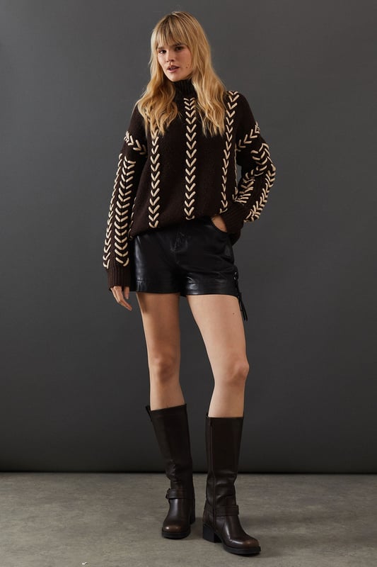 Oversized fit for a relaxed, contemporary silhouette
        Striking whipstitch detail in a contrasting hue
        Long sleeves with dropped shoulders for added comfort
        High neck design for extra warmth and style
        Versatile piece suitable for various casual occasions
    
    This Warehouse jumper radiates confidence with its bold whipstitch detailing and oversized fit. The contrasting stitching creates an eye-catching pattern that runs vertically down the garment, adding visual interest and texture. Perfect for those who appreciate edgy yet feminine style, this jumper can be effortlessly styled for various casual events. Pair it with leather shorts and ankle boots for a night out with friends, or throw it over your favourite jeans for a cosy family gathering. The high neck and long sleeves offer warmth without compromising on style, making it an ideal choice for transitional weather. For a more relaxed look, team it with wide-leg trousers and trainers. This versatile piece allows you to express your unique style while maintaining comfort, embodying the essence of contemporary British fashion.