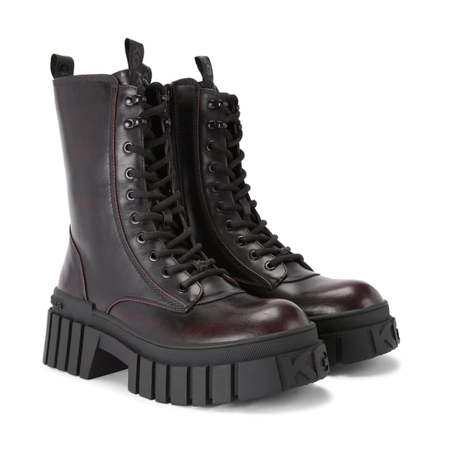 The KG Kurt Geiger Tegan Lace Up boot is a black boot with wine upper which features a KG Kurt Geiger logo printed on ribbed textile with print stitch detailing can be seen at the tongue as well as a black rubber monocle on the tongue.