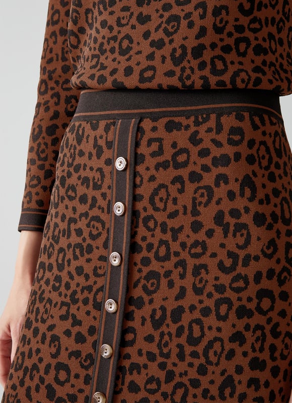 Our Lea pencil skirt works as part of a two-piece with the matching Lea jumper or by itself with a plain knit. Crafted from a brown leopard print slinky fabric, it sits on the waist, has border detail, buttons through and has a slim fit falling to the knee. Match it up to the jumper for a playful autumnal look or wear it with alternative pieces in your wardrobe as a statement skirt.
