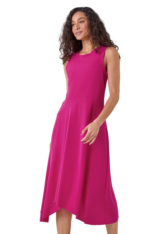 Asymmetric Sleeveless Stretch Midi Dress from Roman. Keep your style simple and chic this season with this sleeveless Dusk midi dress. Cut from a comfortable stretch jersey fabric, this dress features a modest round neckline and a Summer ready sleeveless style. Cut in a flattering fit and flare shape with a floaty asymmetrical hemline, this dress is designed to pull-on for quick and easy dressing. Falling to a modest midi length with a unique diagonal dropped waist, this dress can be dressed up or down to suit any occasion. Add sandals and sunnies for a simple Summertime look!