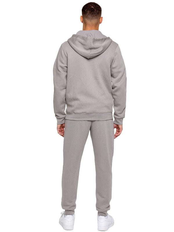 Elevate your everyday look with the Kruze Men’s Tracksuit Set, a perfect blend of comfort, warmth, and style. This set includes a regular-fit zip-up hoodie and matching joggers, both crafted with a cozy brushed-back inner fleece for a soft feel and added insulation on cooler days. The hoodie features an adjustable drawstring hood, ribbed cuffs and hem for a secure fit, and Kruze’s rubber-printed branding on the chest for a touch of signature style. Two convenient side pockets offer space for your essentials. Paired with regular-fit joggers, this tracksuit ensures all-day comfort and a sleek look. The joggers come with a ribbed waistband and adjustable drawstring for a tailored fit, two side pockets for practicality, and ribbed ankles for a streamlined, modern silhouette. A Kruze rubber print on the leg adds subtle branding.