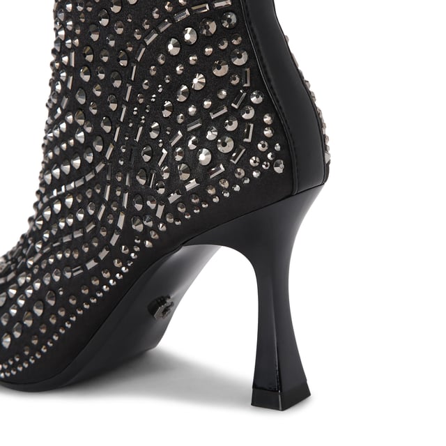 The Carvela Catwalk ankle boot features a black satin upper with gunmetal studs across the upper. The heel is in a flared design. Heel height: 8.5cm.