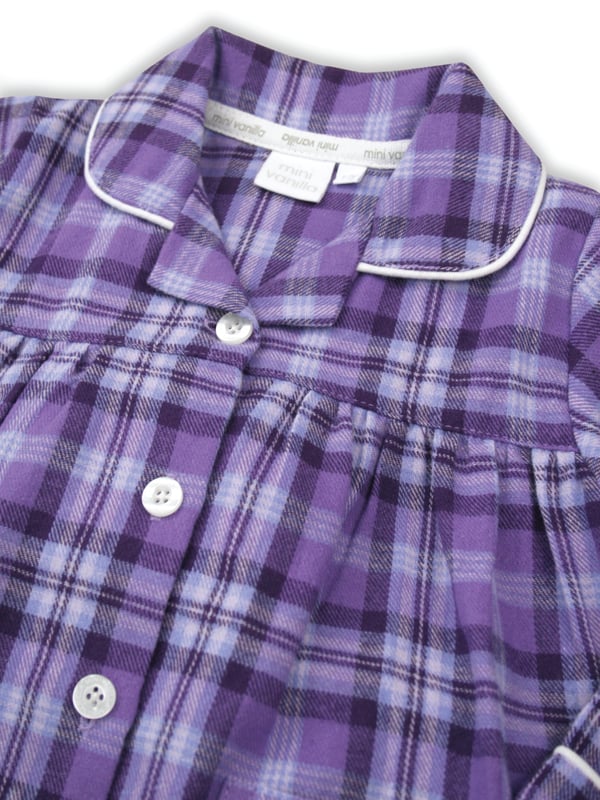 Girls Lilac and Purple Check Traditional Winter Pyjama Set. 

A timeless check is given the Mini Vanilla touch using lilac and purple tones in our kids pyjama set. Made from super-soft and cosy, brushed 100% cotton, the PJ set is trimmed in white cotton. The long-sleeved top has an open collar and fastens with engraved buttons. Fully elasticated at the waist the trousers have a comfy fit.

Our pure-cotton check pyjamas are a beautiful-quality addition to their nightwear collection. Our cotton flannel is brushed, making it unbeatably soft and cosy against the skin and plush to the touch. A great PJ gift for girls too!

Features
Button-through long-sleeved top
Classic Brushed Check Fabric
Contrast piping along collar and cuffs
Elasticated waistband
100% soft brushed Cotton
Machine Washable
Front pockets
Engraved pearl effect buttons