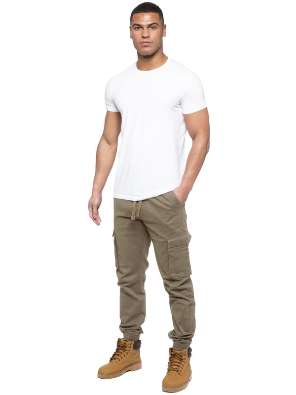 Enzo Mens Elasticated Waist Stretch Cuffed Jeans. Features a 5 Pocket Design. 2 Slash Pockets, 1 Back Pocket 2 Front Cargo, Bellow Side Pockets With Velcro Fastening. Elasticated Waist With Adjustable Drawstings. Cut and Sew Design On Leg. Cuffed Ankle