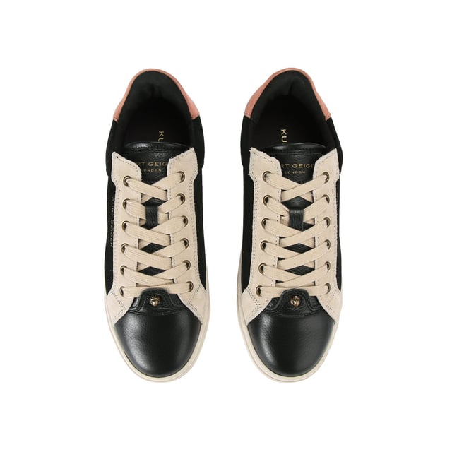 The Kensington Cupsole sneaker features a black suede leather upper with grey and pink panels. The front laces up with antiqued eagle head at the base of the laces. The sole is quilted in rubber.
