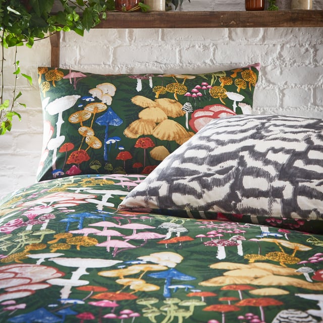 Mushrooms are enjoying their moment in home and fashion designs right now! This is reflected by the amazingly detailed hand-painted Amanita duvet cover set which celebrates the intricate world of fascinating fungi and mystical mushrooms. They glow brightly against the dramatic coloured background, which gives this design a unique twist, alongside surrounding organic shapes. The abstract printed reverse is inspired by the textural underside of a mushroom and is in natural tones for a more neutral look if desired. A fabulous on-trend design which will add both intrigue and a hint of mystery to your bedroom.