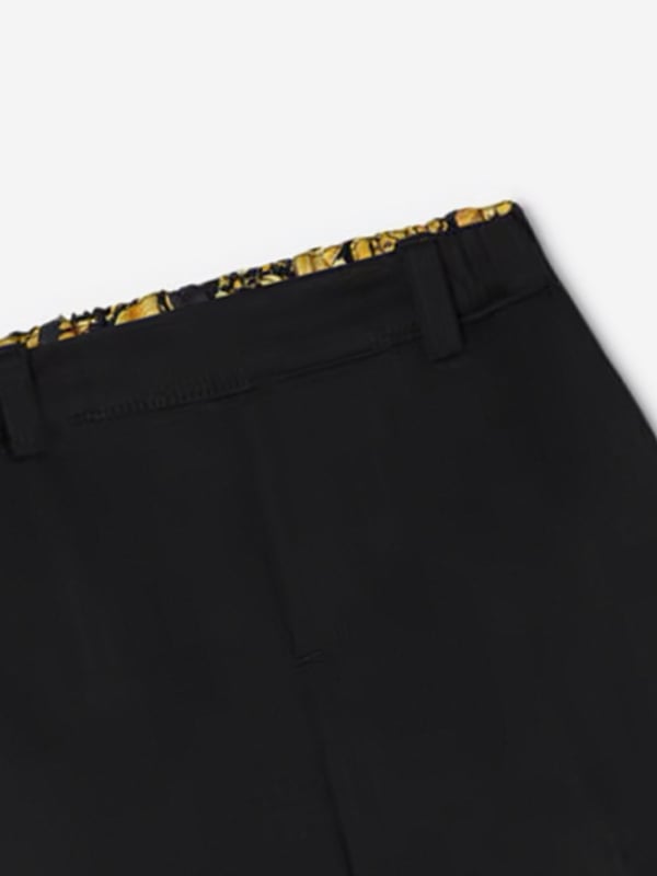 Introducing the Baby Boys Punto Milano Shorts in Black by Versace, a luxurious addition to your little one's wardrobe for AW2024. Impeccably designed in Italy, these shorts merge sophistication with comfort. Highlight features include:‚ Exquisite Italian Craftsmanship: Meticulously tailored for unparalleled quality and enduring style.‚ Chic Versatile Design: Classic black hue enhances any outfit, making it perfect for any occasion.‚ Supreme Comfort: Constructed from soft Punto Milano fabric for all-day wearability.‚ Timeless Versace Elegance: Features subtle designer details that reflect Versace's iconic luxury aesthetic.Elevate your child‚ fashion ensemble this season with these must-have Versace shorts. Shop now!