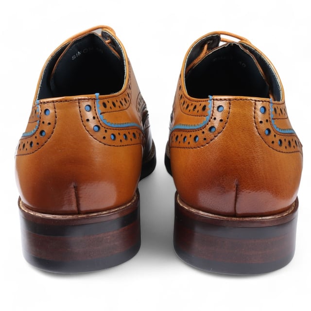 Elevate your formal style with the Justin Reess Simon Men's Brown Brogue Leather Shoes. These classic brogues feature decorative perforations and intricate detailing along the upper, adding a refined touch to any outfit. Made from premium leather, they offer durability and comfort for all-day wear. The lace-up closure ensures a secure, customizable fit, perfect for business meetings, weddings, and other formal occasions. These versatile shoes are a must-have addition to your wardrobe, seamlessly complementing any formal ensemble.

Classic Brogue Design with decorative perforations
High-Quality Leather Construction for durability and style
Lace-Up Closure for a secure, adjustable fit
Versatile Formal Wear suitable for various occasions