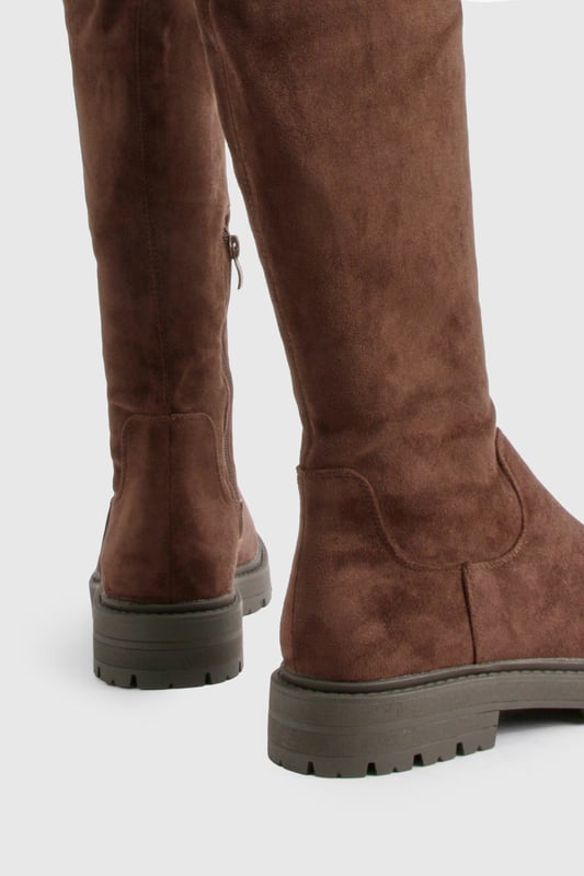 Knee-high boots with chunky silhouette
        Faux suede upper for a luxe look
        Flat heel (0-2cm) for all-day comfort
        Robust cleated sole for enhanced grip
        Side zip closure for easy on-and-off
    
    Make a bold statement with these eye-catching knee-high boots from Boohoo. The chunky silhouette and faux suede finish create a striking look that's perfect for the fashion-forward trendsetter. Designed with comfort in mind, the flat heel allows for effortless all-day wear, while the cleated sole provides excellent traction on various surfaces. Style these versatile boots with a flowy midi dress and oversized jumper for a chic autumn ensemble, or pair them with skinny jeans and a leather jacket for an edgy night-out look. Whether you're heading to a casual family gathering or a day out with friends, these boots will keep you on-trend and comfortable from dawn to dusk.