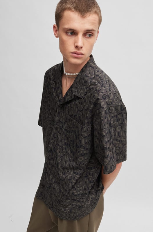 short sleeve shirt - reverse lapels - button closure - poplin - allover print - tag print - animal metal stacked logo - small metal stacked HUGO logo - RESPONSIBLE.A statement shirt in an oversized fit by HUGO Menswear. Designed in breathable cotton poplin  this short-sleeved piece is printed with a seasonal motif.