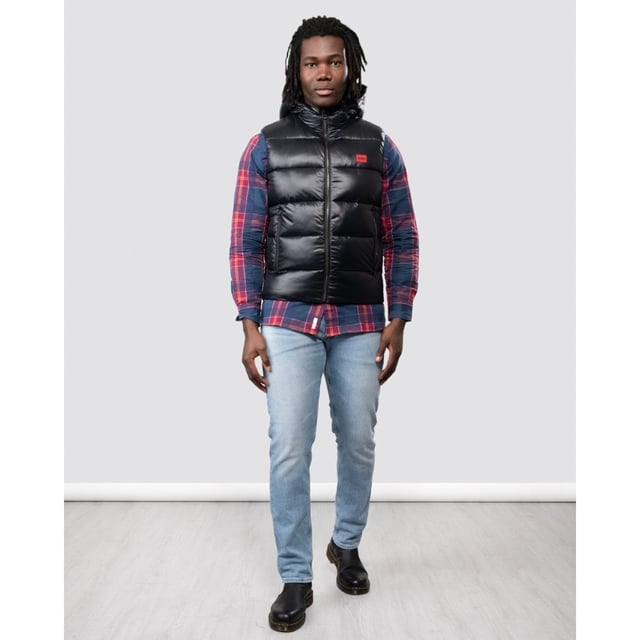 This sporty Water Repellent Puffer Hooded Gilet from HUGO is the perfect piece to elevate your wardrobe this season with sustainable style. Crafted from water-repellent recycled nylon and padded with sustainably sourced recycled fibres providing warmth and comfort. Featuring an insulated hood with full zip closure, elasticated binding and front zip pockets. Finished with a signature HUGO logo patch on the chest.Slim Fit, Water-Repellent Recycled Nylon Shell, Recycled Polyester Padding, Insulated Hood, Full Zip Closure, Twin Zip Front Pockets, Internal Zip Pocket, HUGO Branding. -Style & Fit:Slim Fit, Fits True to Size. Composition & Care:Shell: 100% Recycled Polyamide, Fill: 100% Recycled Polyester, Machine Wash.
