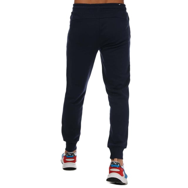 Mens Puma Essentials Logo Sweatpants in navy.- Elasticated waist with inner drawcord.- Two front pockets.- Ribbed ankle cuffs.- Printed branding.- Brushback fleece.- Regular fit.- Shell: 66% Cotton  34% Elastane. Rib: 97% Cotton  3% Elastane.- Ref: 58671476