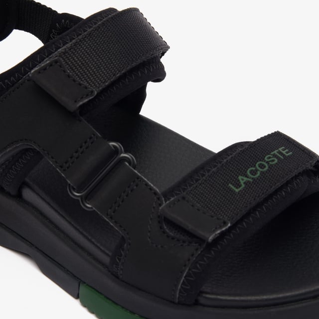 • Padded neoprene cushioning under straps • Synthetic leather footbed • Rubberised print Lacoste wording to front strap • Crocodile heel branding to rear strap • Lightweight rubber outsole with colour-blocked sections.