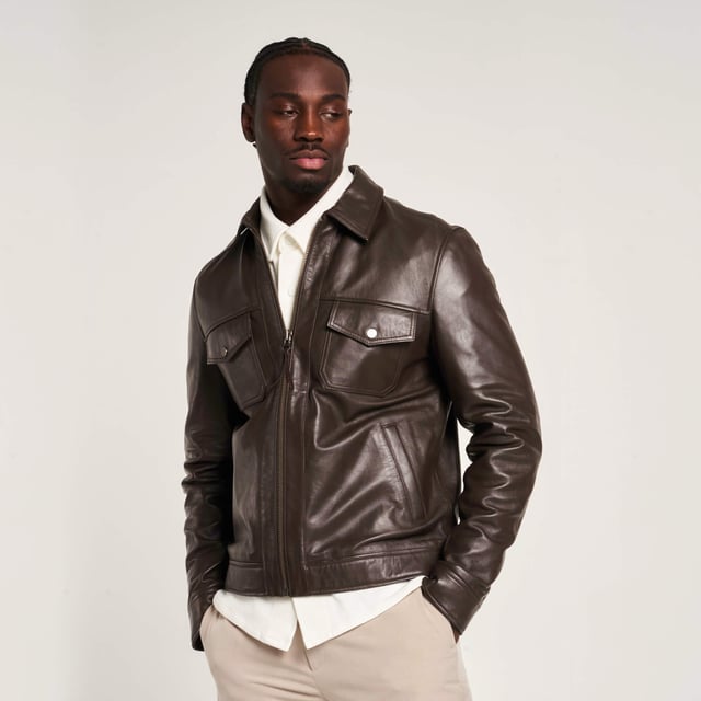 Introducing the Barneys Originals Brown Leather Harrington jacket - a timeless piece crafted for the modern adventurer. With its rich brown hue and classic Harrington silhouette, this jacket exudes rugged sophistication. Perfect for any occasion, whether you're exploring the city streets or unwinding in the countryside, it's the epitome of versatile style and enduring quality.