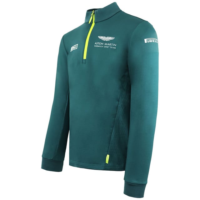 La camiseta Aston Martin F1 Official Team Men's Green Midlayer es una prenda elegante y funcional diseñada para los entusiastas de la Fórmula 1 y los seguidores del Aston Martin Cognizant F1 Team. Estas son las principales características de esta capa intermedia para hombre:

 Mercancía oficial del equipo:  Esta capa intermedia es mercancía con licencia oficial del equipo Aston Martin Cognizant F1, lo que garantiza que representa la marca y la calidad del equipo.

 Diseño verde:  La capa intermedia es predominantemente verde, lo que refleja el color característico del equipo y añade un toque deportivo y elegante a tu atuendo.

 Estilo de la capa intermedia:  Una capa intermedia suele estar diseñada para proporcionar una capa extra de calidez y comodidad sin ser demasiado voluminosa. Es ideal para llevar debajo de una chaqueta o encima de una camiseta.

 Marca del equipo Aston Martin F1:  La capa intermedia suele llevar la marca del equipo, incluidos logotipos y otros elementos asociados a la escudería de Fórmula 1, mostrando tu apoyo y pasión por el equipo.

 Cierre con cremallera: Suele incluir un cierre frontal con cremallera, que permite llevarla fácilmente y regular la temperatura.

 Construcción de calidad:  Los artículos oficiales de Fórmula 1 son conocidos por su calidad, y esta capa intermedia está diseñada para mantener su forma y estilo con el uso regular.

 Uso versátil:  Tanto si asistes a una carrera de F1 como si la ves desde casa o simplemente sigues con tu día a día, esta capa intermedia ofrece calidez y estilo, permitiéndote expresar tu pasión por el deporte y el equipo.

 Uso diario:  Aunque es perfecta para los eventos y carreras de F1, esta capa intermedia también es adecuada para el uso diario, añadiendo un toque deportivo y de moda a tu atuendo diario.