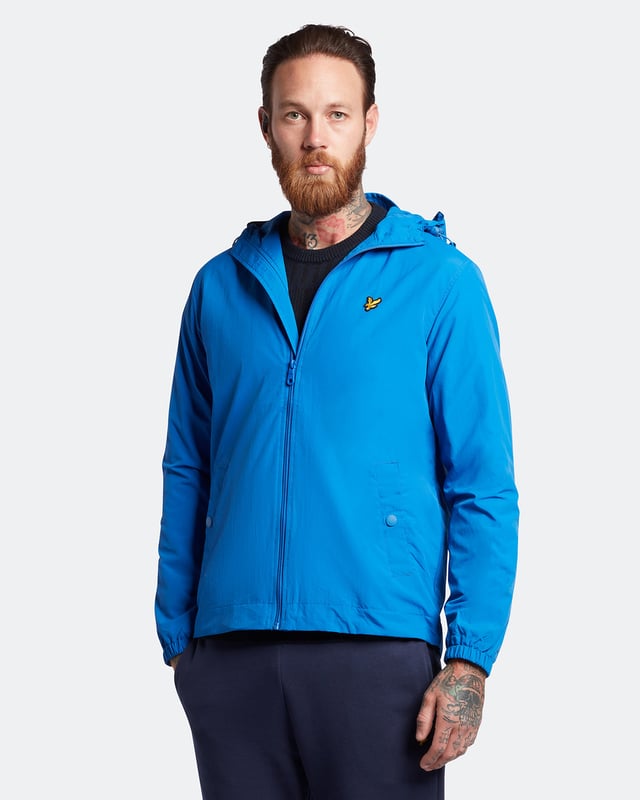 One of our most versatile styles, the Lyle & Scott Hooded Jacket is designed in a lightweight, durable Nylon blend. Featuring an elasticated drawstring at hem and hood, designed to lock in warmth, with an internal mesh lining ensures breathability throughout. Finished with peaked hood, button front pockets, detail stitching, and our signature Golden Eagle.  
  
Fit: Regular
It is crafted to fit the body neither too tightly or too loosely, leaving you with a classic, timelessly stylish look. We recommend you order your usual size, but if you're caught between two, go a size up.