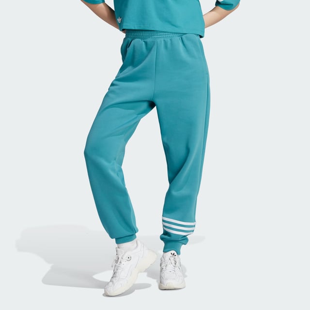 Stay sharp even when the day calls for relaxation. These adidas Adicolor joggers blend a sporty vibe with stylish design to make sure you look good even in your downtime. 3-Stripes around one leg add an unexpected, asymmetrical look to the casual, laid-back piece. Whether you're chilling at home or need to step out of the house, these relaxed-fit pants make sure you always look on point.A minimum of 70% of this product is a blend of recycled and renewable materials.  - This model is 175 cm and wears a size S. Their chest measures 81 cm and the waist 60 cm. - Relaxed fit - Drawcord on elastic waist - 66% cotton, 34% polyester (recycled) - Side zip pockets - Elastic cuffs  Shipped by adidas