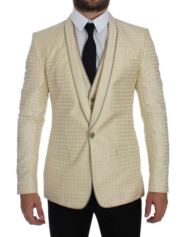 Brand: Dolce & Gabbana
  Style: 2 Piece Single breasted two button blazer and vest
  Fitting: Slim fit
  Color: Beige and gold
  Three outside pockets and two inside pockets
  One open vent in the back
  4 button closure vest with adjustable back strap
  Logo details
  Made in Italy
  Material: 58% Polyester 42% Silk
  Lining: 51% Acetate 49% Rayon
Material: 58% Polyester 42% Silk
