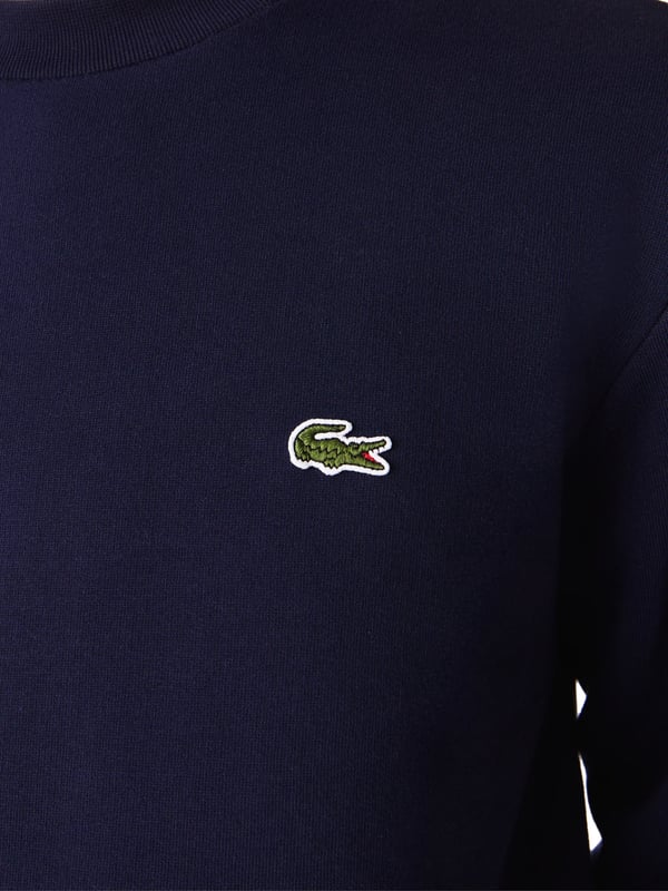 Solid-colored sweater with a round neckline, ribbed cuffs and subtle logo patches in a regular fit.