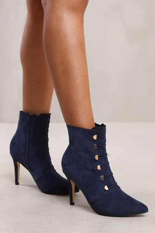 Step out in style with our Leane Pointed Toe Mid Heel Ankle Boots with Gold Buttons. These fashionable ankle boots are designed to add a touch of sophistication and flair to any outfit.Key Features:



Chic Design: The pointed toe and gold buttons on these ankle boots create a stylish and eye-catching look. These boots effortlessly elevate your style, making you stand out from the crowd.

Comfortable Fit: Despite their sleek design, these ankle boots prioritize your comfort. The mid heel provides a comfortable lift, while the pointed toe allows for a snug fit and adds a touch of elegance.

Durable Construction: Made with high-quality materials, our Pointed Toe Mid Heel Ankle Boots with Gold Buttons are built to last. The sturdy construction and reliable stitching ensure their durability, making them perfect for everyday wear.

Easy to Wear: These ankle boots feature a convenient side zipper closure, allowing for easy on and off. The gold buttons add an extra touch of luxury to the design.


Specifications:


Material: Faux Suede
Closure: Zip
Heel Height: 3.9 inches
Toe Shape: Pointed Toe

Invest in our Leane Pointed Toe Mid Heel Ankle Boots with Gold Buttons for a perfect combination of style, comfort, and sophistication. Make a statement and turn heads wherever you go. Get yours today and step into a world of fashionable elegance!