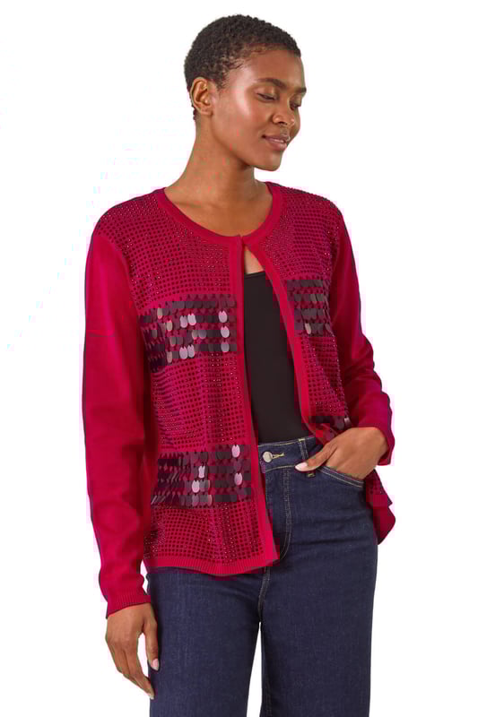 Sequin Embellished Knit Cardigan from Roman. Add a touch of sparkle to your Autumn Winter look with this luxurious sequin embellished knit cardigan. Designed with intricate sparkly details, this soft, knitted long-sleeve cardigan is perfect for any smart or casual event. With a unique front fastening detail and a round neckline featuring hook and bar features, this cardigan is a classic addition to your outfit. Simply style with wide-leg trousers and ankle boots!