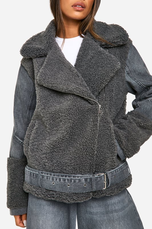 Cosy teddy fabric body with contrasting denim sleeves
        Oversized notched lapel collar for added warmth
        Asymmetric zip front closure for a modern twist
        Wide belt with metal buckle to cinch the waist
        Relaxed fit perfect for layering over chunky knits
    
    Make a bold statement this season with our eye-catching Teddy-Fliegerjacke. This unique hybrid design combines the warmth of a teddy coat with the edgy appeal of a denim jacket. The plush teddy fabric body keeps you snug, while the rigid denim sleeves add a cool, contrasting texture. Style it with wide-leg jeans and trainers for a casual weekend look, or throw it over a midi dress and ankle boots for a night out with the girls. The versatile nature of this jacket makes it perfect for various casual occasions, from coffee dates to family gatherings. The oversized collar and waist-cinching belt allow you to customise your look, making this piece a true wardrobe staple that you'll reach for time and time again.