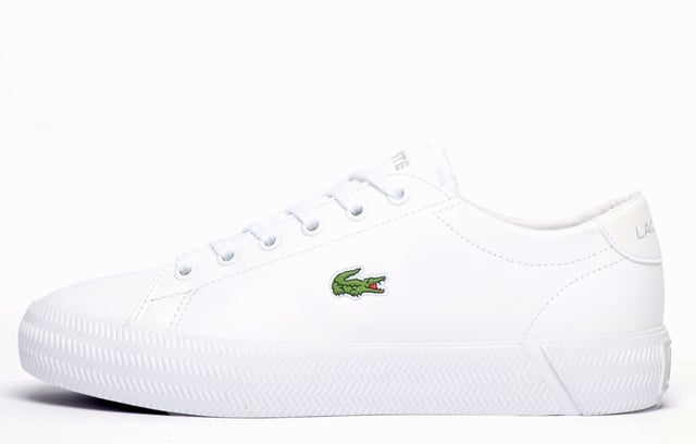 Lacoste Gripshot Womens Trainers With its premium leather construction and classic, low-profile silhouette presented in a smart white colourway, the Lacoste Gripshot delivers a look thats both casual and stylish. Full of designer touches, premium craftmanship and finished off with the famous Lacoste Croc on the side, this no-nonsense trainer will deliver a touch of laid-back style to any casual or dress outfit.
- Premium Leather upper
- 6 eyelet lace up fit
- Ortholite footbed
- Textured vintage styled midsole
- Durable rubber outsole
- Lacoste branding throughout
PLEASE NOTE:
These Lacoste trainers are sold as B grades which means there may be some very slight cosmetic issues on the shoe and they come in a Lacoste box with the Lacoste brand authenticity details attached to it. We have checked every pair of these shoes and in our opinion at these heavily reduced prices all are very saleable. All shoes are guaranteed against fair wear and tear and offer a substantial saving against the normal high street price. The overall function or performance of the shoe will not be affected by cosmetic issues. B Grades are original authentic products released by the brand manufacturer with their approval at greatly reduced prices. If you are unhappy with your purchase we will be more than happy to take the shoes back from you and issue a full refund. Possible imperfections may include some, all, or on some occasions none of the issues stated: Scuff marks to the upper; glue spots to the upper; general discolouring imperfections to the upper, occasionally some discolouring of the sole. If there are visible marks on the shoe which is very rare, once the shoes have been worn two or three times any initial marks will blend into the overall appearance of the shoes.