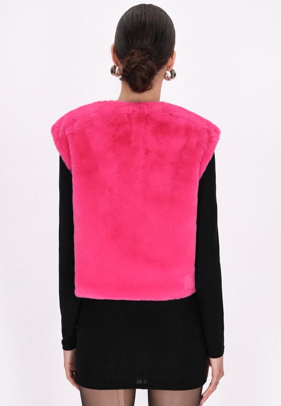 Geef je wintergarderobe een boost met dit funky, mouwloze vest met kort bont. De zachte buitenkant en binnenvoering zorgen voor warmte en comfort, perfect voor koude dagen. Met een V-hals, verborgen sluiting en rechte zoom biedt het een casual maar stijlvolle look. Dit wintervest is gemaakt voor een moderne jonge vrouw en houdt je het hele seizoen lang behaaglijk.  Waistcoat