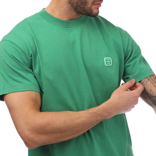 Ambush Monogram Patch T-Shirt in green.- Ribbed crew neck.- Short sleeves.- Logo patch at the chest.- Slim fit.- 100% Cotton.- Ref: BMAA0130015555