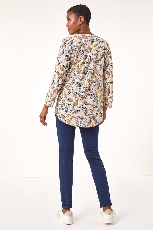 Button Detail Leaf Print Blouse from Roman. Stand out this Autumn in this charming leaf print blouse. Featuring a striking all-over leaf design, this blouse comes complete with a sophisticated button-through centre front for easy wear. The addition of tabs on the sleeves adds a touch of casual chic to this statement piece. Pair with your favourite jeans and trainers for a stylish and trendy look that will take you from day to night effortlessly.