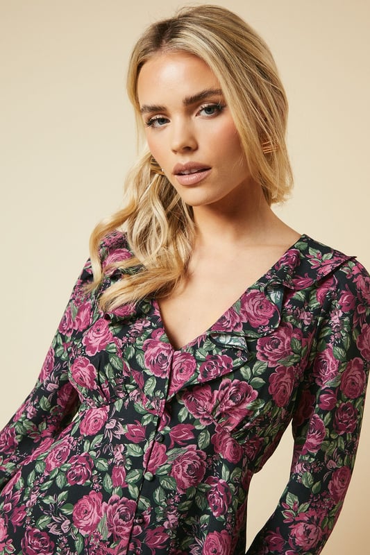 Charming floral print blouse with a romantic ruffle neck detail
        Flattering V-neckline with button-front closure for easy wear
        Long sleeves with subtle gathering at the shoulders for a feminine touch
        Elegant tie-back detail to accentuate the waistline
        Versatile tea blouse style suitable for various casual occasions
    
    Embrace effortless elegance with this Dorothy Perkins petite floral blouse. Perfect for the fashion-conscious woman in her 30s, this piece strikes the ideal balance between trendy and modest. The ruffle neck and button-front design add a touch of vintage charm, while the long sleeves provide comfort and coverage. Style this versatile top with slim-fit trousers and ballet flats for a chic brunch look, or pair it with dark denim and ankle boots for a casual family gathering. The tie-back detail allows for a customised fit, ensuring you look polished whether you're attending a baby shower or meeting friends for coffee. This blouse is a wardrobe essential that seamlessly transitions from day to evening, making it the perfect choice for the modern woman who values both style and practicality.