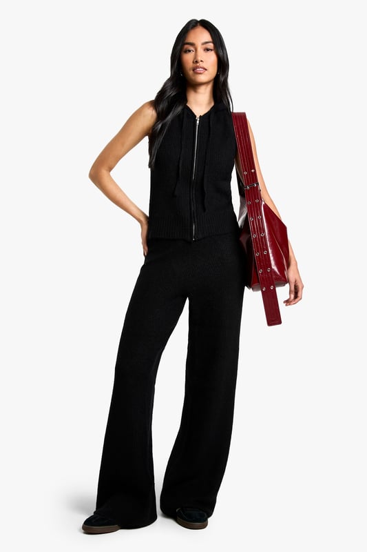 Sleeveless knit hoodie and wide-leg trouser set
        Hooded neckline with adjustable drawstring
        Ribbed knit texture for added interest
        Wide-leg trousers for a relaxed silhouette
        Versatile two-piece design for mix-and-match styling
    
    Embrace laid-back luxury with this chic co-ord set from Boohoo. The sleeveless knit hoodie offers a contemporary twist on athleisure, while the wide-leg trousers create a flowing, elongated silhouette. Perfect for casual outings or lounging at home, this set can be dressed up or down with ease. Pair with trainers and a crossbody bag for a trendy daytime look, or style with heeled mules and statement earrings for an evening out with friends. The ribbed knit texture adds a tactile element, making this set both comfortable and stylish. For cooler days, layer a long-sleeved top underneath the hoodie or throw on an oversized denim jacket. The versatility of this co-ord allows for endless styling possibilities, making it a must-have addition to your wardrobe.