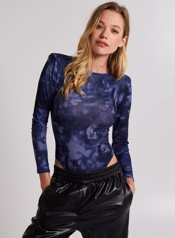 Nail the major trend this season with this bodysuit. Featuring a stonewash print with long sleeves and shoulder pads.