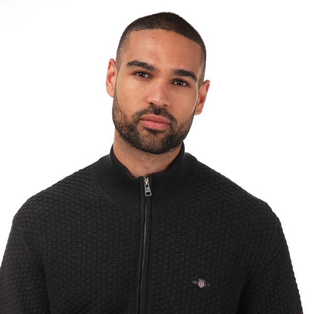 Mens Gant Cotton Zipped Cardigan in charcoal.- Funnel neck.- Full zip fastening.- Rib texture.- GANT logo embroidered at the chest.- Relaxed fit.- 100% Cotton. - Ref: 803017397
