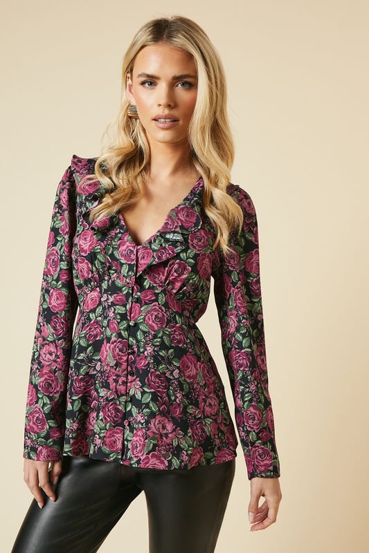 Charming floral print blouse with a romantic ruffle neck detail
        Flattering V-neckline with button-front closure for easy wear
        Long sleeves with subtle gathering at the shoulders for a feminine touch
        Elegant tie-back detail to accentuate the waistline
        Versatile tea blouse style suitable for various casual occasions
    
    Embrace effortless elegance with this Dorothy Perkins petite floral blouse. Perfect for the fashion-conscious woman in her 30s, this piece strikes the ideal balance between trendy and modest. The ruffle neck and button-front design add a touch of vintage charm, while the long sleeves provide comfort and coverage. Style this versatile top with slim-fit trousers and ballet flats for a chic brunch look, or pair it with dark denim and ankle boots for a casual family gathering. The tie-back detail allows for a customised fit, ensuring you look polished whether you're attending a baby shower or meeting friends for coffee. This blouse is a wardrobe essential that seamlessly transitions from day to evening, making it the perfect choice for the modern woman who values both style and practicality.