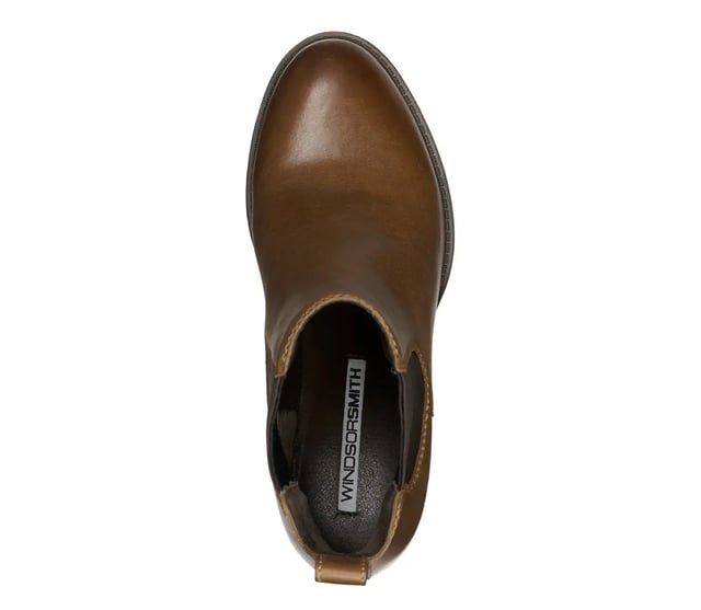 The Windsor Smith Varsity boots showcase a classic Chelsea silhouette, expertly crafted with a sleek leather upper. Featuring double-sided knit elastic gussets for a snug fit, these boots blend style and comfort effortlessly. The almond toe shape and 70 mm mid block heel provide an elegant touch, making them a versatile choice for any occasion.

Elegant Leather Upper: High-quality leather for a sophisticated look and feel.
Comfortable Non-Leather Lining: Soft lining that ensures breathability and comfort.
Durable Non-Leather Sole: Designed for longevity and reliable wear.
Stylish Mid Block Heels: 70 mm heel height provides a perfect blend of elevation and stability.
Convenient Leather Pull Tabs: For easy on-and-off access, enhancing usability.
Snug Fit Design: Double-sided knit elastic gussets ensure a secure and comfortable fit.
Chic Almond Toe Shape: Adds a refined touch to the classic Chelsea boot style.