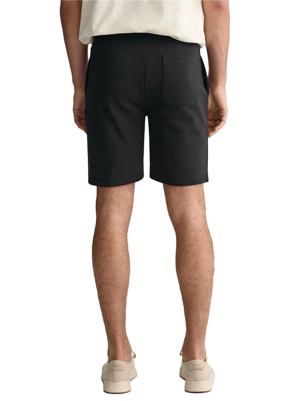 These classic sweat shorts are crafted from a soft cotton blend and tailored for a regular fit. Featuring a ribbed waistband for enhanced comfort, the design includes two front pockets, a single back pocket, and a drawstring waist. Completing the look, the shorts are adorned with a small-scale shield graphic embroidered on the left leg.