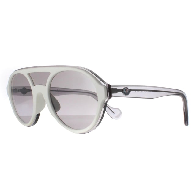 Moncler Round Unisex White Transparent Grey Grey ML0052  Sunglasses are a modern round style featuring a top bar for added comfort. The lightweight acetate frame features the Moncler logo on the temples for brand recognition.