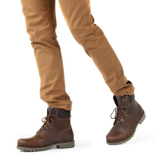 Step Out in Style and Comfort with Panama Jack Boots Whether you're trekking through rugged countryside trails or navigating urban streets, the original Panama Jack 03 C8 Mens Lace Up Boot is your perfect companion. Boasting a classic design with a plain round toe and a brown padded leather collar, these boots exude timeless elegance. The stitched commando sole ensures durability and stability on any terrain. For the gentlemen, the Men's Brown Panama Jack 03 Lace-up Ankle Boots are designed to withstand the elements. Featuring a waterproof smooth nubuck upper, soft padded ankle shaft, and warm lining, these boots keep your feet cozy and dry. The embossed logo on the heel and hexagonal metal eyelets add a touch of sophistication to their rugged charm. Key Features: Classic Design: The Panama 03 boots blend design, quality, and comfort seamlessly, offering a timeless aesthetic for both men and women. Versatile Wear: Whether you're exploring the city streets or conquering mountain trails, these boots are perfect for all your daily adventures. Waterproof Construction: Crafted from waterproof vintage nappa leather with leather lining, these boots ensure your feet stay dry and comfortable in any weather. Anatomical Support: Enjoy enhanced comfort and hygiene with the anatomically formed insole that provides a perfect fit for your feet. Durable and Slip-Proof: The rubber outsole offers flexibility, durability, and slip-proof traction, providing stability on various surfaces. Made in Spain: With a shaft height of 18 cm, these boots are expertly crafted in Spain, ensuring superior craftsmanship and quality. Step into Panama Jack boots and experience the perfect blend of style, durability, and comfort for your everyday adventures. Made for those who appreciate quality and craftsmanship, these boots are your trusted companion wherever your journey takes you
