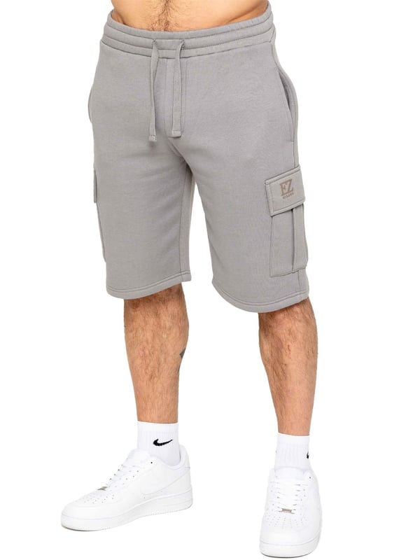 Experience comfort and style with Enzo's Men's Cargo Fleece Shorts. Made with brushed back inner fleece, these shorts offer a regular fit with 2 side pockets and 2 cargo pockets. The elasticated waistband, featuring the EZ logo, is adjustable with a drawstring for the perfect fit.