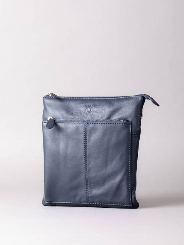 Welcome portable style into your handbag collection with the slimline yet pocket-packed Enderby cross body bag in easy-to-style navy.Crafted from soft and smooth leather, this bag features a large front zip and rear zip pocket on the outside for easy access valuables, and the interior boasts zip and slip pockets to ensure you stay organised on the go.The adjustable shoulder strap makes the Enderby ideal for everyday use, big enough for your essentials but superbly lightweight.The DetailsStyle: Enderby Leather Cross Body BagColour: NavyMaterial: LeatherDimensions: W22 x H24 x D2cmAdjustable leather strapAdjustable strap drop: Max 76cm - min 36cmZip top fastening with leather pullerLarge front zip pocketRear zip pocket And On The InsideOne zip pocketOne slip pocketFabric lining