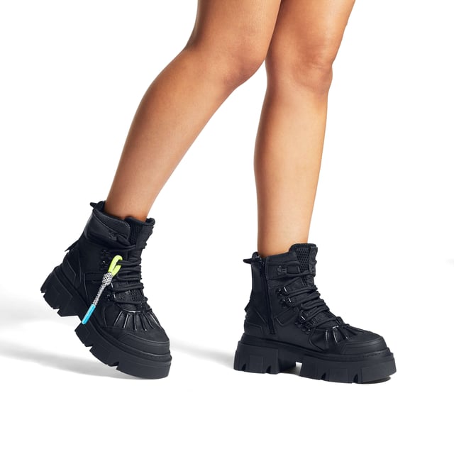 The Trekker Pumped Hiker boot features iconic branding across the upper. KG Kurt Geiger logo printed on ribbed textile with print stitch detailing can be seen at the tongue as well as a black rubber monocle on the heel.