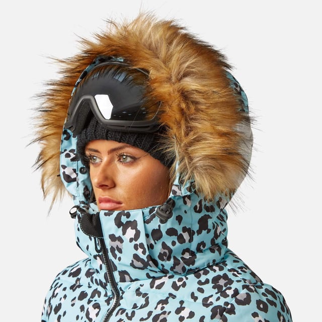 The Surfanic Fiore ski and snowboard jacket is a popular street-styled high-performance mountain jacket for all occasions. Classic feminine design with premium warmth, this low loft puffer jacket is filled with 100% recycled insulation that warms up as quickly as it dries out, for all-day comfort. This street-styled block gives you the right mix of form and function.

The Surftex 10K outer shell provides excellent waterproof protection from the winter elements, while the 10K breathability rating allows body heat and moisture to escape through the fabric for optimum comfort throughout the day. The jacket's shell fabric has a high-performance durable coating with taped seam construction that offers exceptional heat retention in cold conditions and a high level of breathability that ensures excess heat doesn't form into condensation on the inside of the jacket.

The detachable hood has a 3-way volume adjuster for increased all-round visibility when you are flying down the mountain and require the added protection of having your hood up and when the weather offers you a challenging day. The water-resistant front zipper has an internal reinforced storm flap for increased comfort and protection.

Powder skirt - Whether you're hitting the powder on skis or snowboard, this snow skirt creates a tight seal around your waist to keep the snow out and the warmth in. Made from durable waterproof materials and an internal dry butt patch (DBP) to keep it all warm and dry.

Snow cuff / wrist gaiter - This is perfect for even the most extreme conditions, featuring a tight seal that bridges the gap between your glove and jacket.

Zipped pockets - Pockets designed for everything plus a few more just in case. Pockets for goggles, lift pass, media, stash pocket for cash, wallet pocket and inside phone pocket for protection and to keep the battery warm and dry. Plus a detachable goggle wipe for those days when visibility is at a premium.

Design features:

    Detachable fur
    3-way volume adjusting hood
    Super soft chin guard
    Zipped sleeve ski pass pocket
    Snow cuffs with thumb loop
    Media pocket
    Goggle pocket
    Mesh-lined pit zips
    Detachable goggle wipe
    Twin zipped tricot lined hand warmer pockets
    Reinforced internal storm flap
    Waterproof snow skirt
    Dry butt patch (DBP)

Fabric & performance:

    Bomber fit
    Shell 100% polyester
    Water resistant coating 10,000mm
    Breathbility rating MVP 10,000 gm²

Insulation & lining:

    100% recycled polyester low loft insulation.
    Insulation. 80 gm² body 40 gm² Sleeves
    Lining 100% recycled embossed polyester.