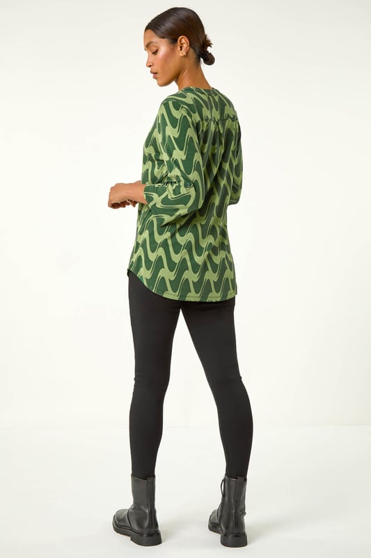 Geometric Print Stretch Blouse from Roman. Elevate your wardrobe this season with our stunning abstract blouse. The bold print and woven silhouette make it versatile for any occasion. The notch neckline, adjustable 3/4 length sleeves and front button details adds a touch of sophistication. Pair it with black jeans and boots for a daytime look or add tailored trousers perfect for those desk-to-dinner days