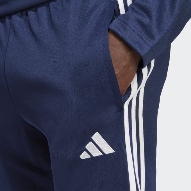 Essential training gear from adidas. Before you hit the pitch for that chilly winter session, layer up in these Tiro 23 Club football pants. Their slim, streamlined fit and moisture-absorbing AEROREADY will keep you flying through sprints and rondos. Once you reach perfect temperature, ankle zips make pulling them off over your boots a breeze.Made with 100% recycled materials, this product represents just one of adidas' solutions to help end plastic waste.  - Slim fit with mid rise - Elastic waist with drawcord - 100% polyester (recycled) - AEROREADY - Side zip pockets - Ankle zips  Shipped by adidas